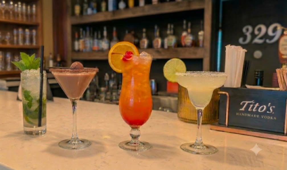 A row of 329 cocktails on the bar — mojito, chocolate martini, hurricane and margarita