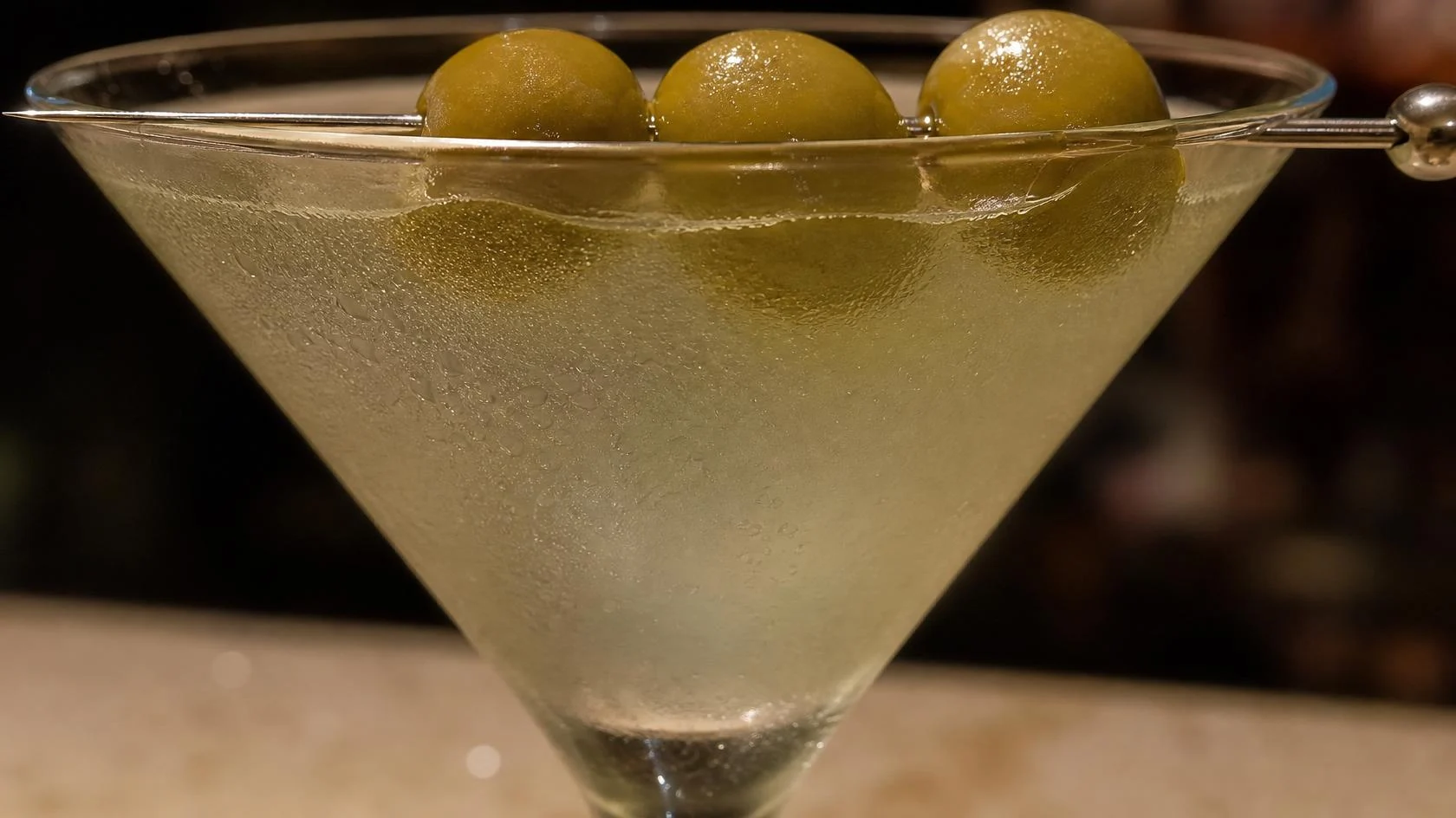 Dirty martini with three olives