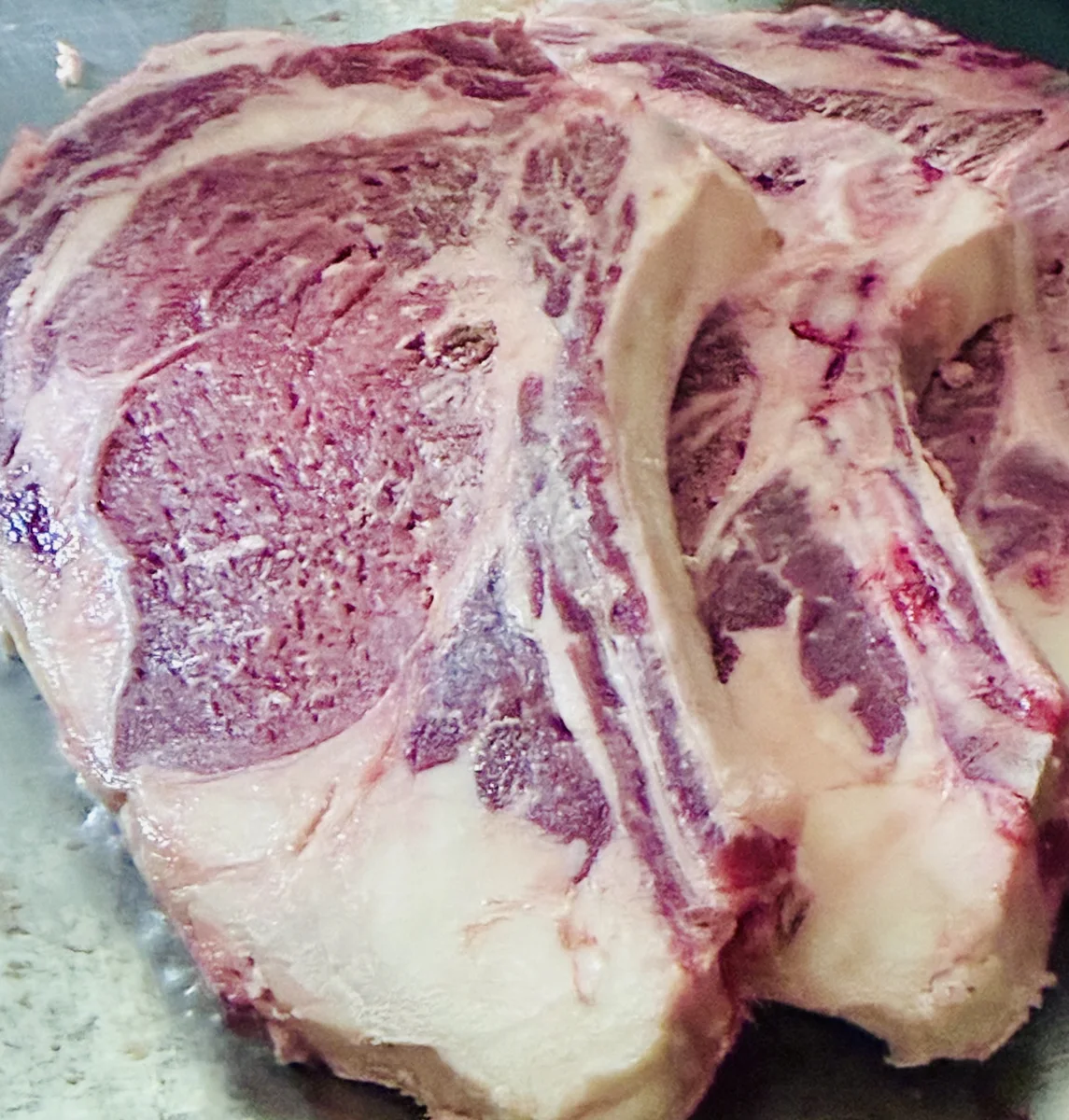 A bone-in ribeye before it is cut